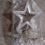 Window curtain string lights with star-shaped decorations