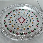 Silver plated pooja thali for religious ceremonies.